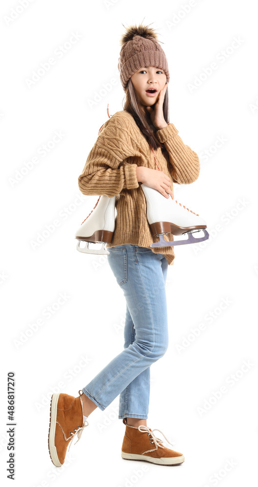 Surprised little Asian girl in warm clothes with ice skates on white background