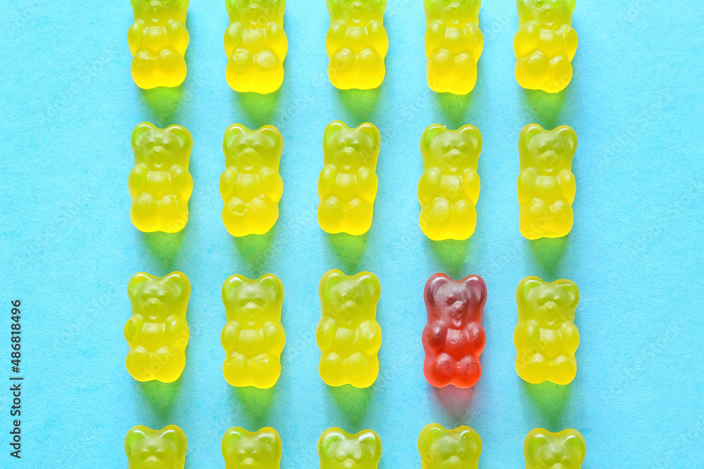 Sweet jelly bears on blue background. Concept of uniqueness