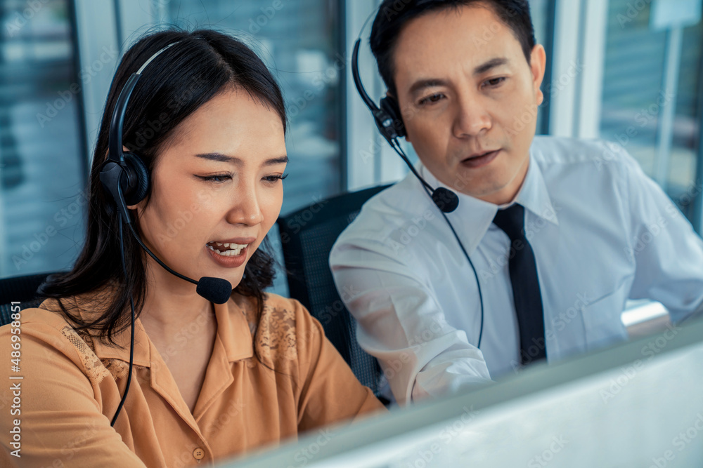 Business people wearing headset working actively in office . Call center, telemarketing, customer su