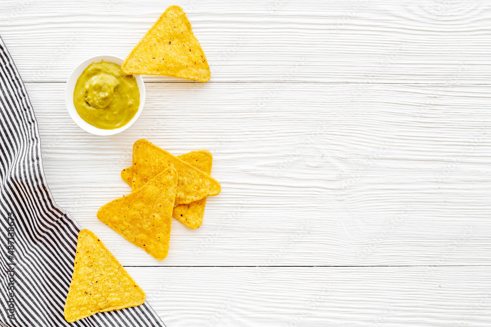 Corn nachos chips with avocado guacamole top view