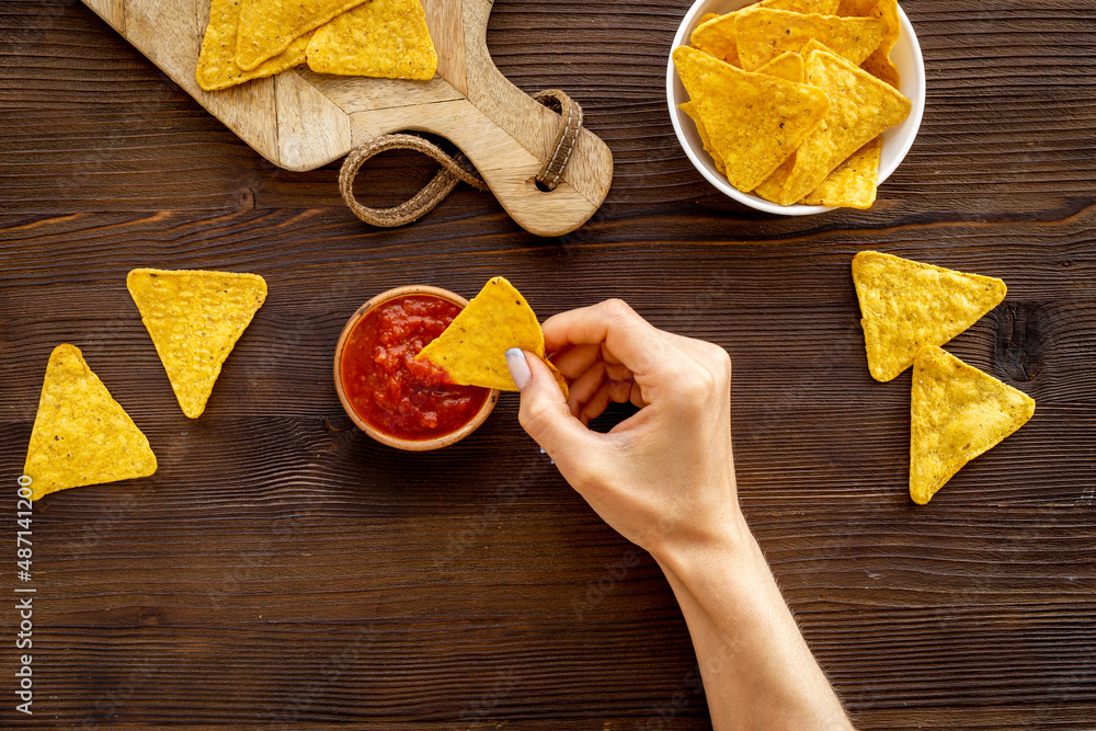 Mexican food nachos chips with tomato salsa sauce, top view