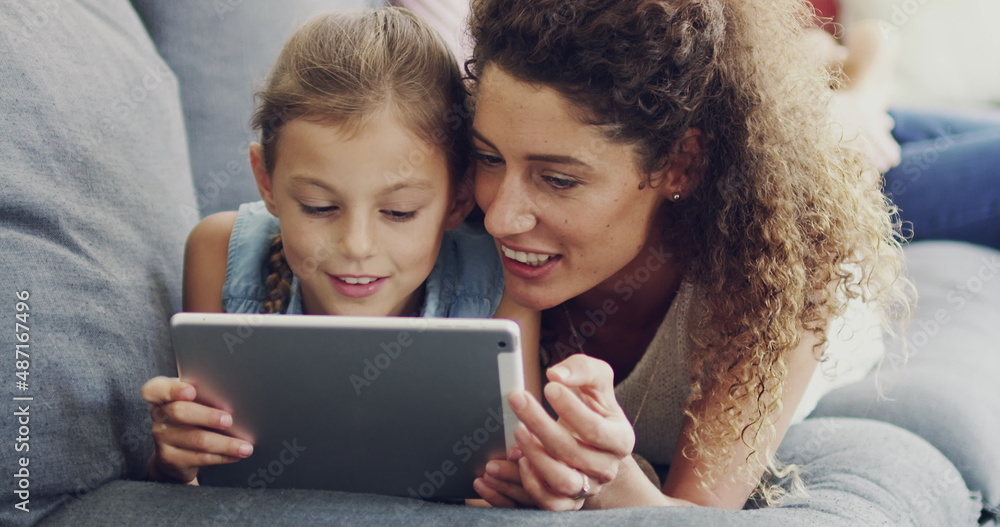 Sharing her daughters internet interests. 4k video footage of a mother and her little daughter lying