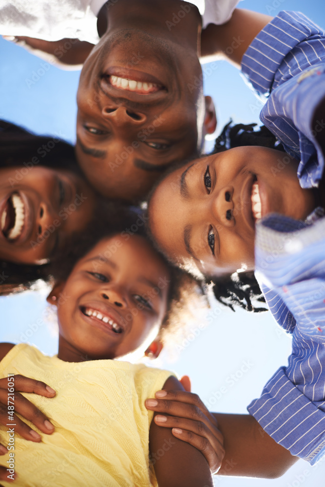 Putting their heads together. Low view portrait of a happy african-american family spending the day 