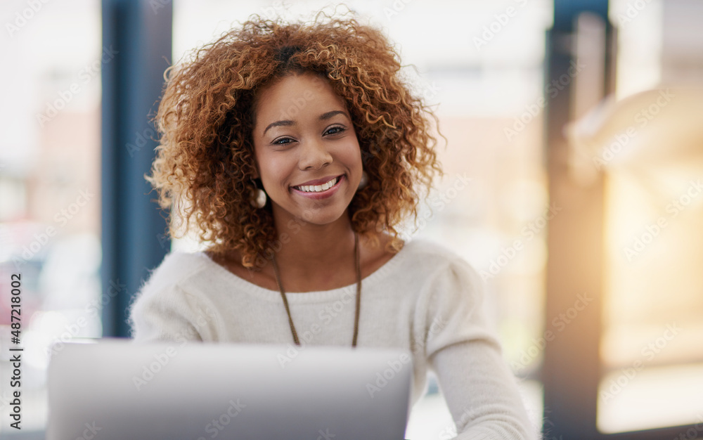 Building her business on success at a time. Portrait of a young businesswoman sitting at her laptop 