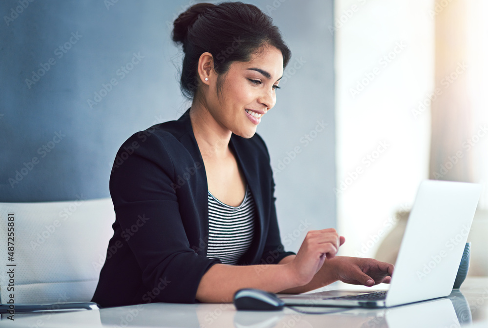 Job satisfaction Check. Cropped shot of an attractive young businesswoman working on a laptop in her