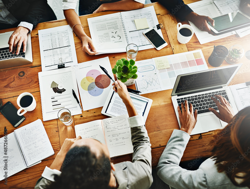 Reading into what happening in their business. High angle shot of a group of businesspeople having a