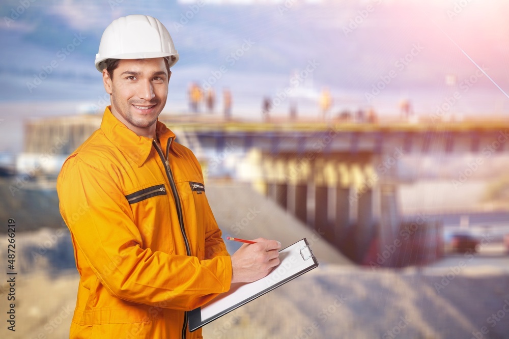 A young coal mine foreman wearing a hard hat work on site