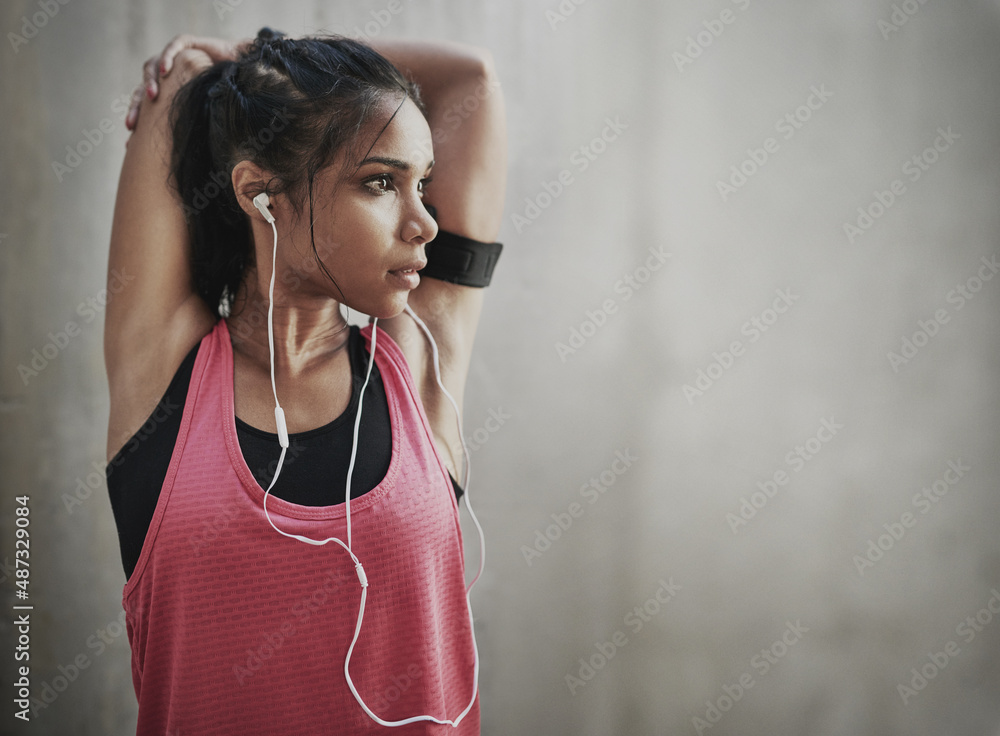 Time to get my fit on. Shot of a young woman getting fit outside.