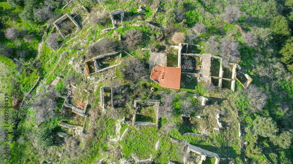 Ruins of traditional stone houses, rural depopulation in Cyprus. Aerial view directly above