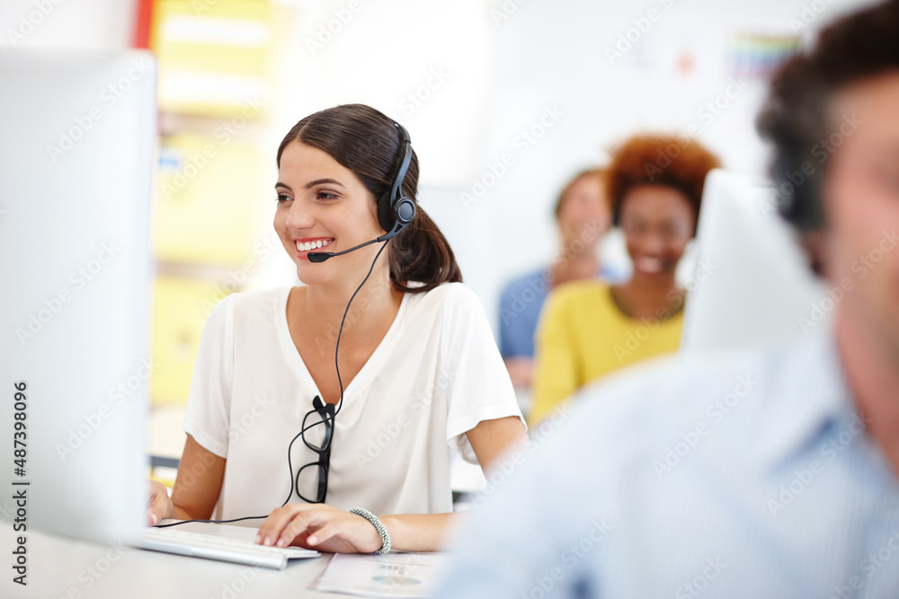 Shes ready to assist. Cropped shot of an attractive young call center operator in the office.