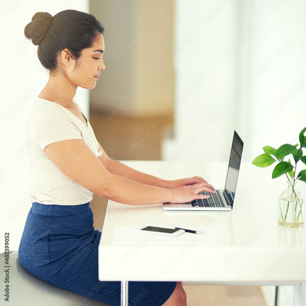 Small business, big dreams. Cropped shot of a young businesswoman working on her laptop at home.