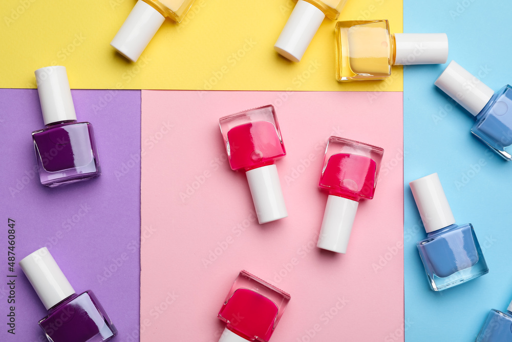 Set of nail polish bottles on color background