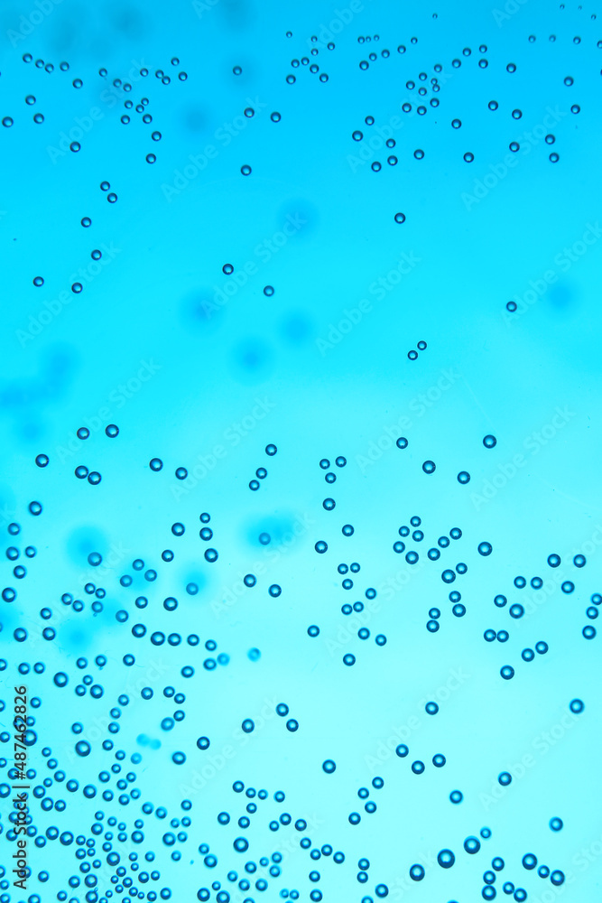 Clear water with air bubbles on blue background