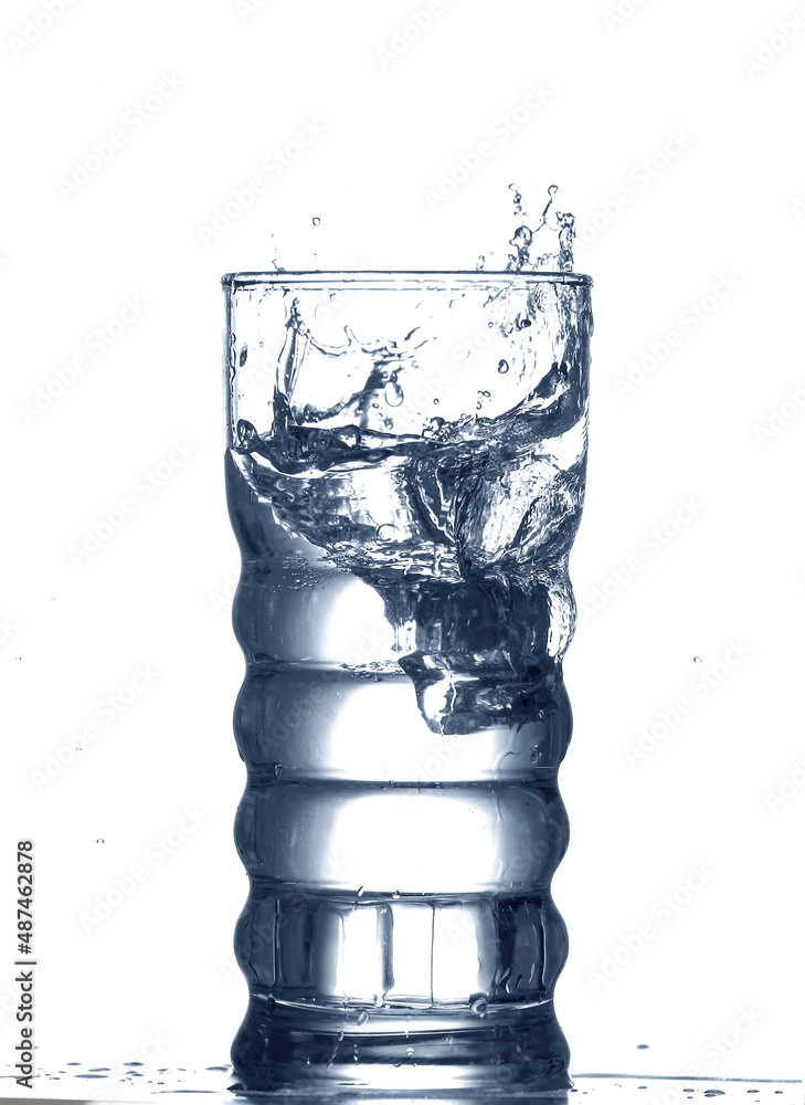 Glass of clear water with splash isolated on white