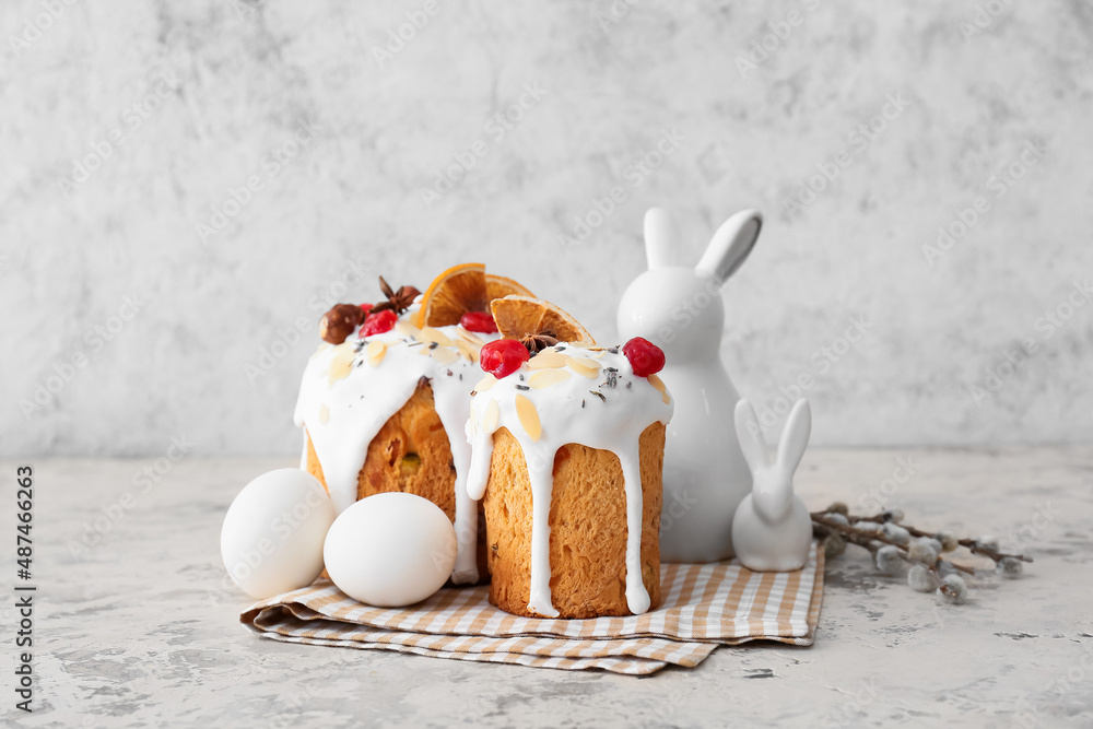 Delicious Easter cakes, eggs and pussy willow branches on light background