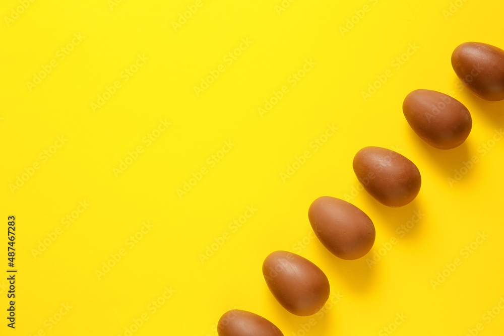 Chocolate Easter eggs on yellow background