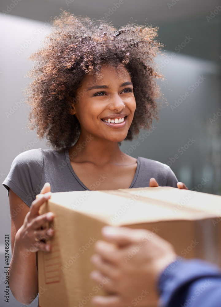 Delivering direct to your door. Shot of a courier making a delivery to a smiling customer.