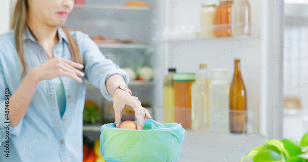 woman is pouring food waste