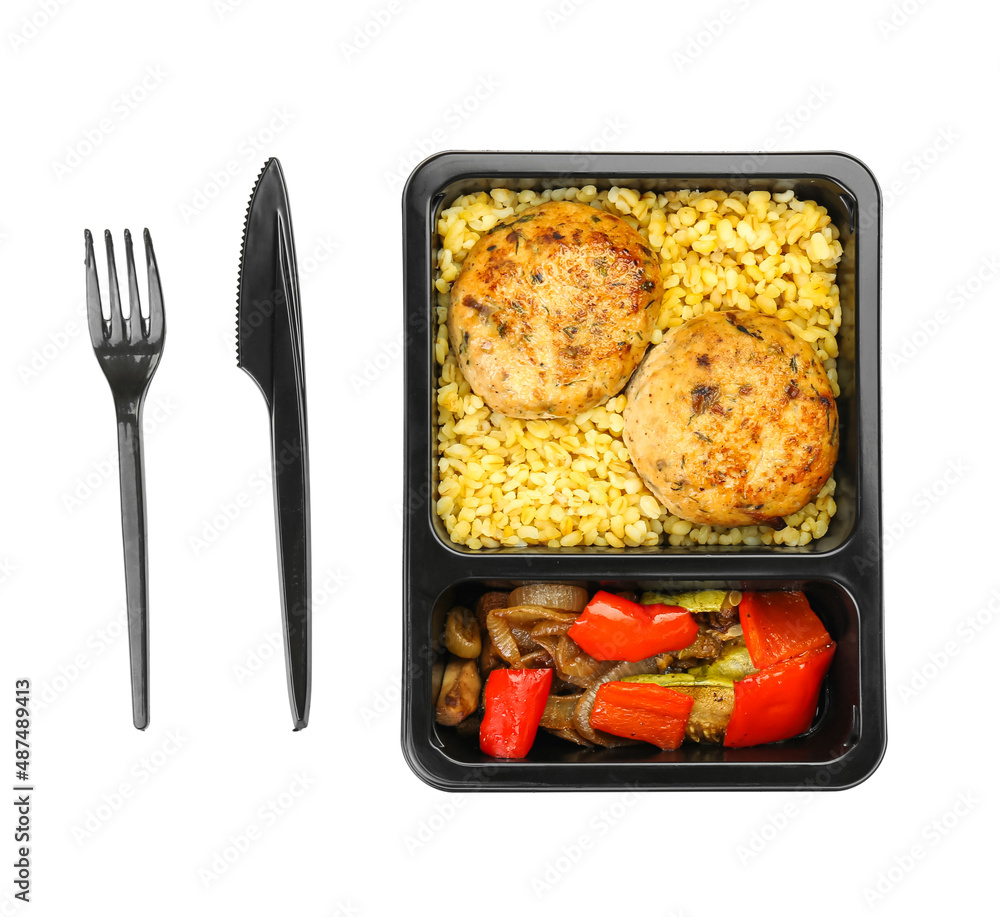 Cutlery and lunch box with delicious food on white background