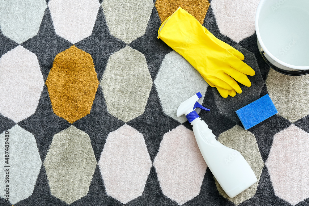 Cleaning supplies on colorful carpet