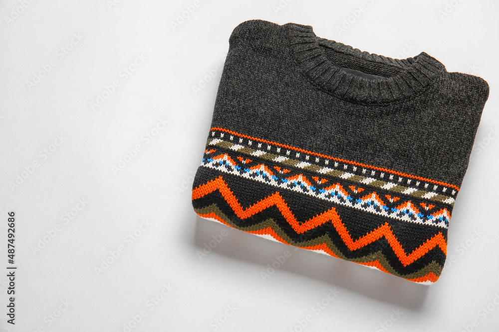 Dark sweater with stylish pattern on grey background