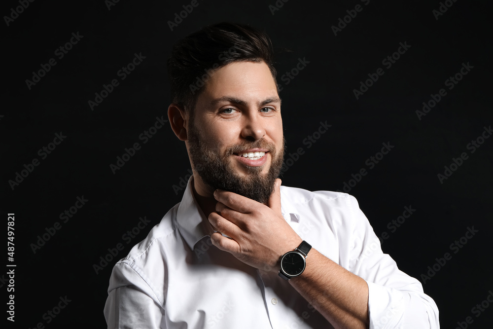 Stylish bearded man on dark background