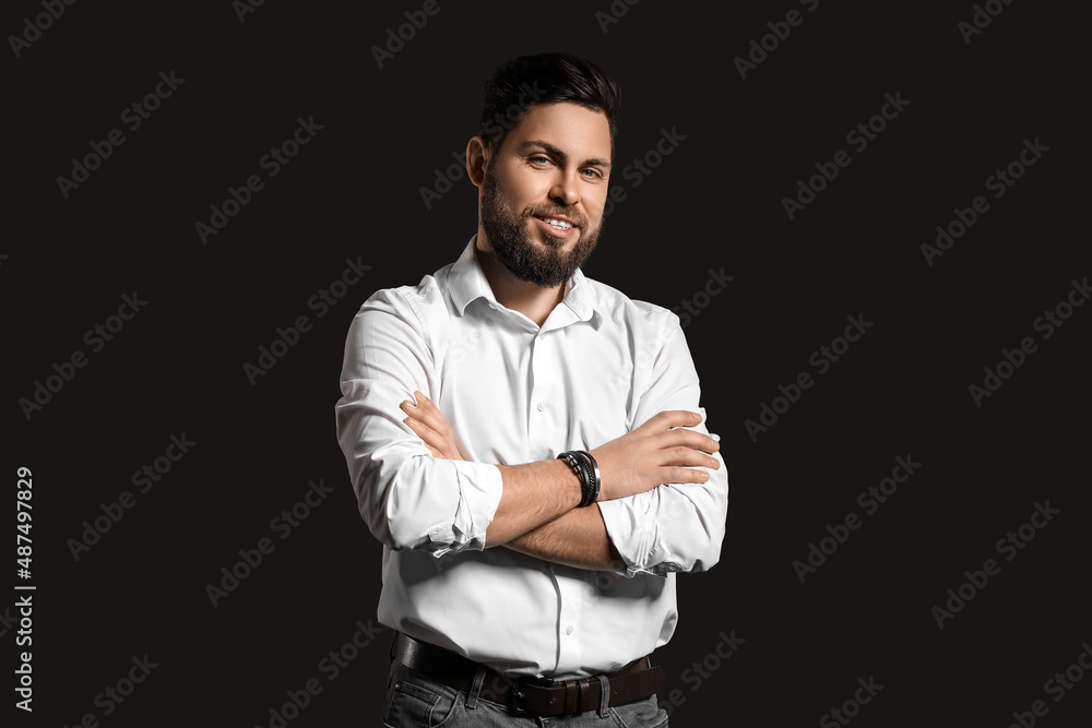 Stylish bearded man on dark background