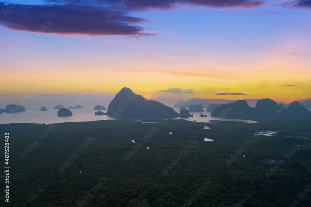 Aerial view drone shot of beautiful sunrise sky in the morning sunrise over sea and mangrove forest 