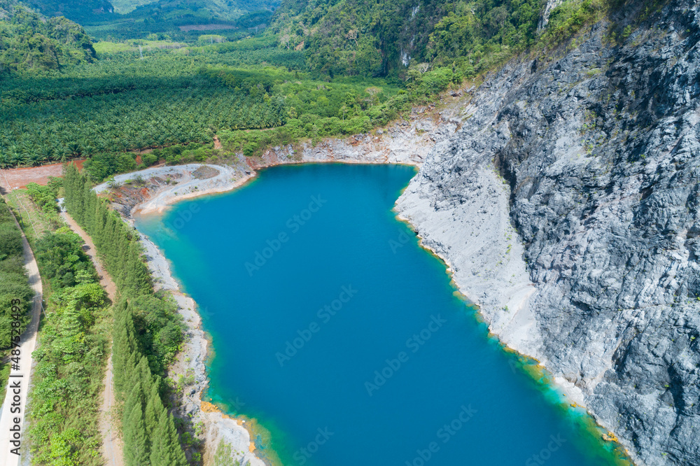 Aerial view of amazing pond in tropical rainforest forest with mountain rocks peak Beautiful water s