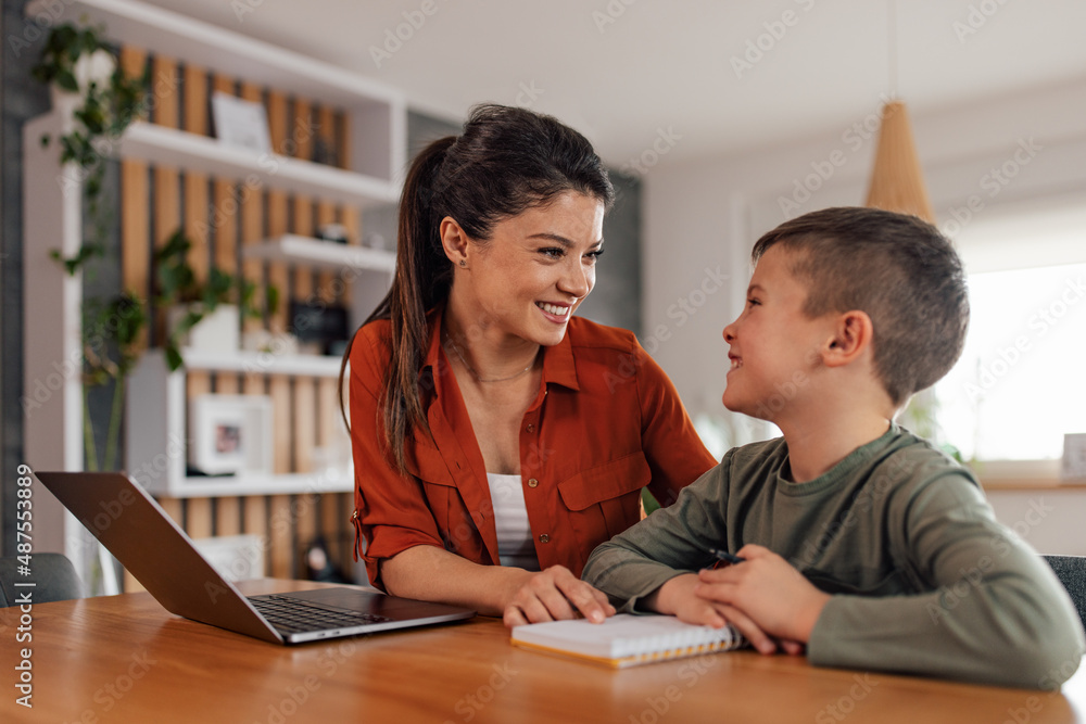 Mothers love for her son, helping him with his tasks, after school, looking at each other.