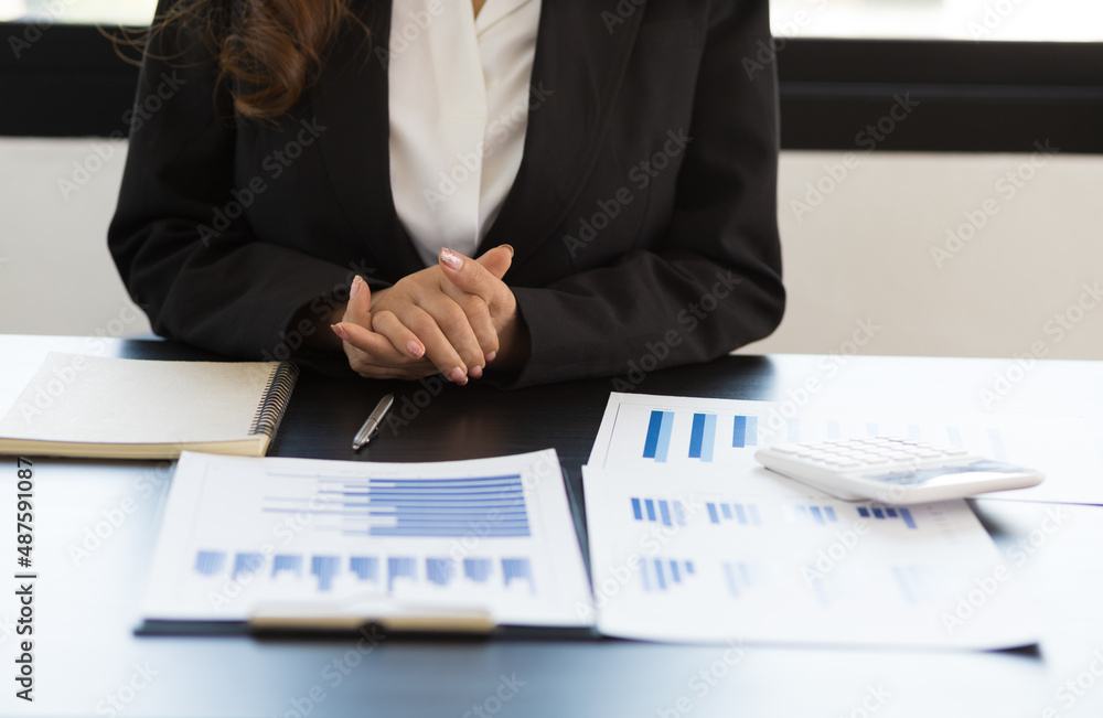 Business women in the office sitting at their desks.