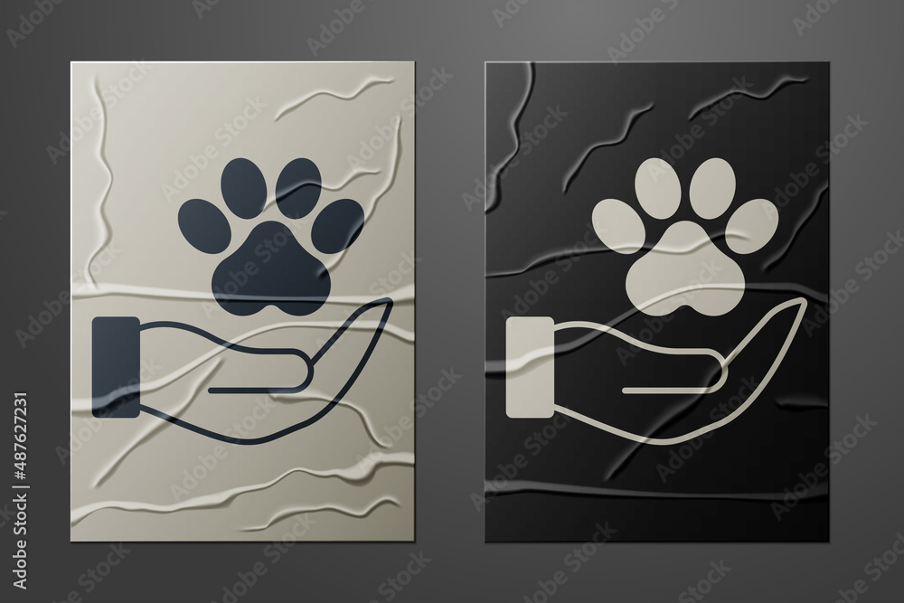 White Hands with animals footprint icon isolated on crumpled paper background. Pet paw in heart. Lov