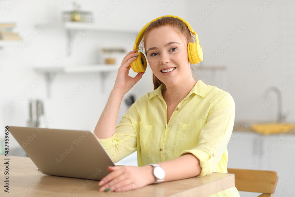 Cool young woman listening to music at home