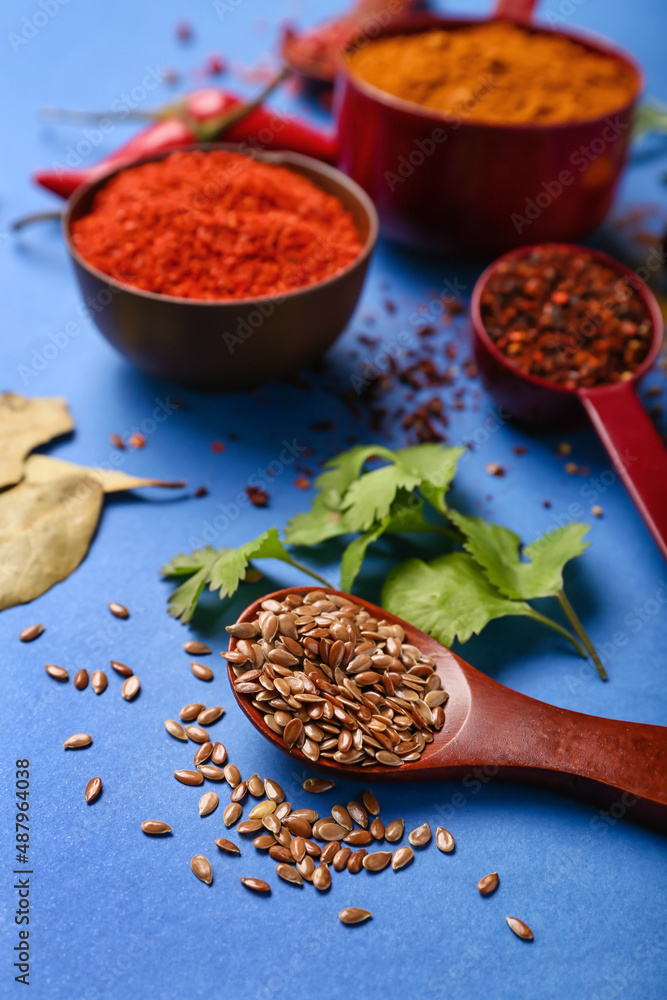 Aromatic spices on blue background, closeup