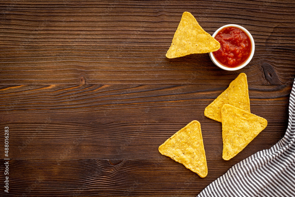 Mexican tortilla corn chips nachos with salsa sauce in bowl