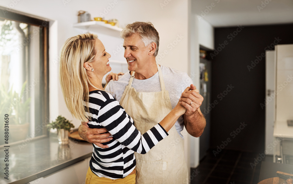 Remember our first dance, my love. Shot of a happy mature couple keeping each other company in the k