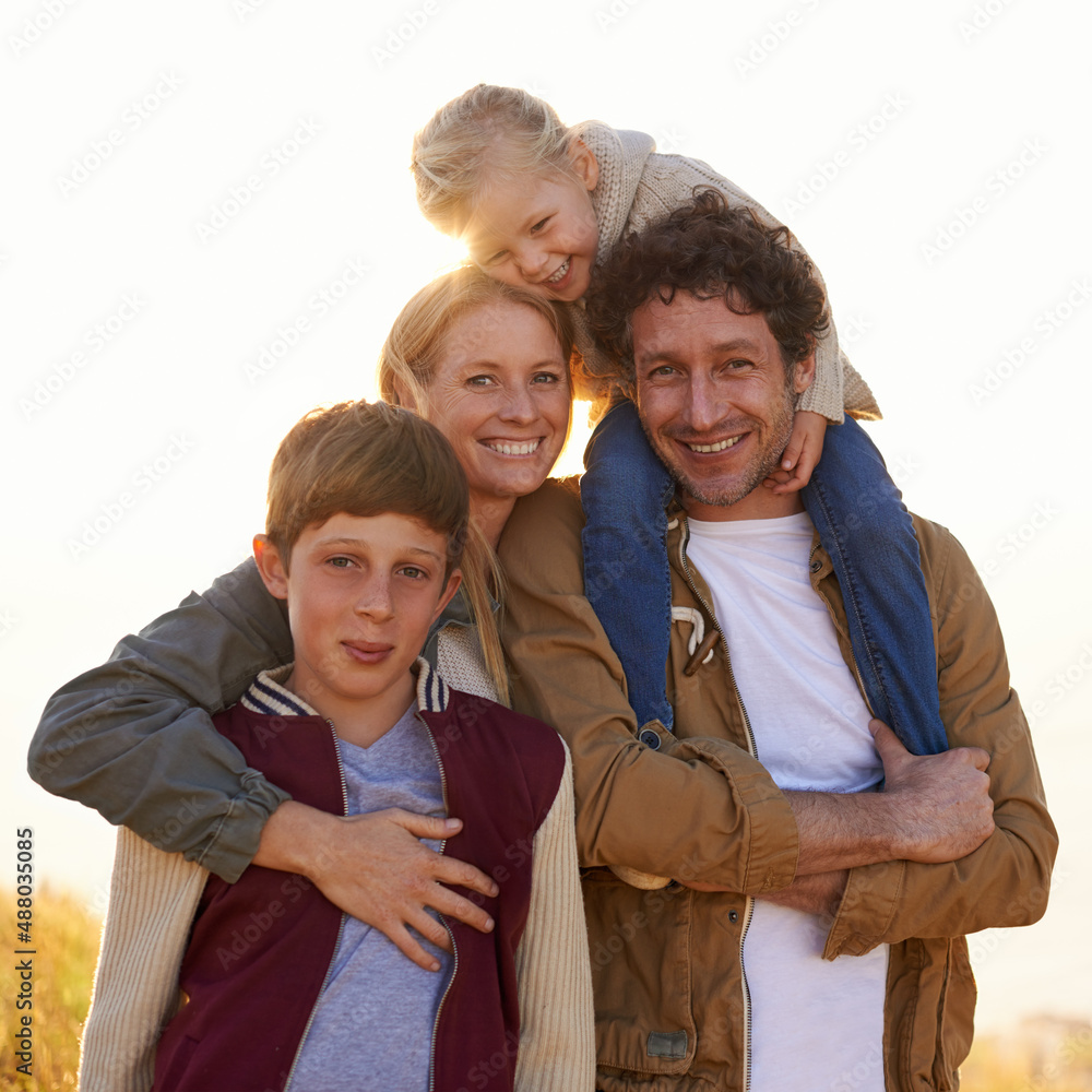 Keep your loved ones close. Portrait of a happy family out on a morning walk together.