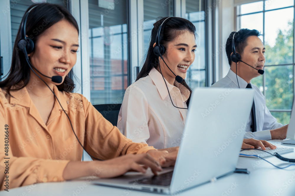 Business people wearing headset working actively in office . Call center, telemarketing, customer su