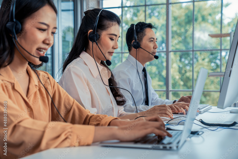 Business people wearing headset working actively in office . Call center, telemarketing, customer su