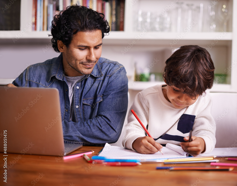 Hes such a clever kid. Shot of a father helping his son with his homework.