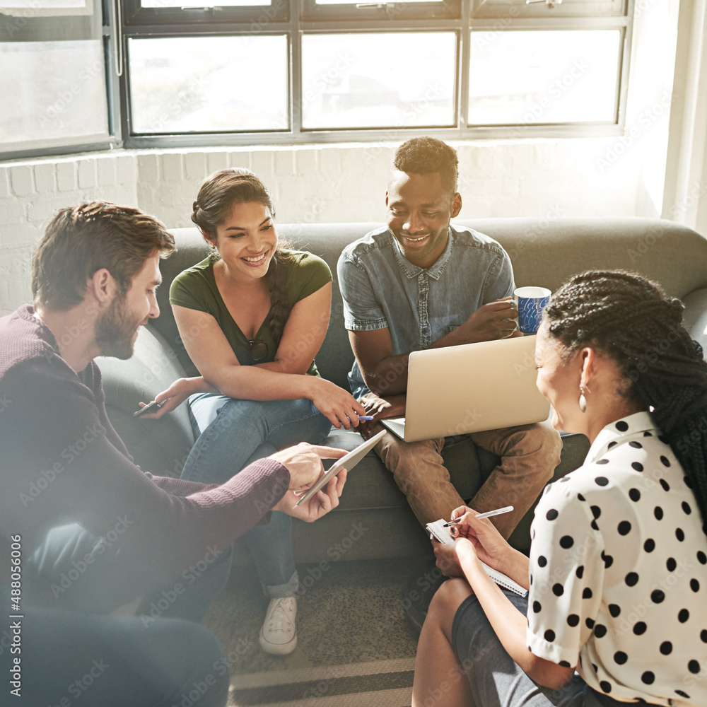 Change of scenery to inspire creativity. Shot of a team of colleagues having a meeting on a sofa in 