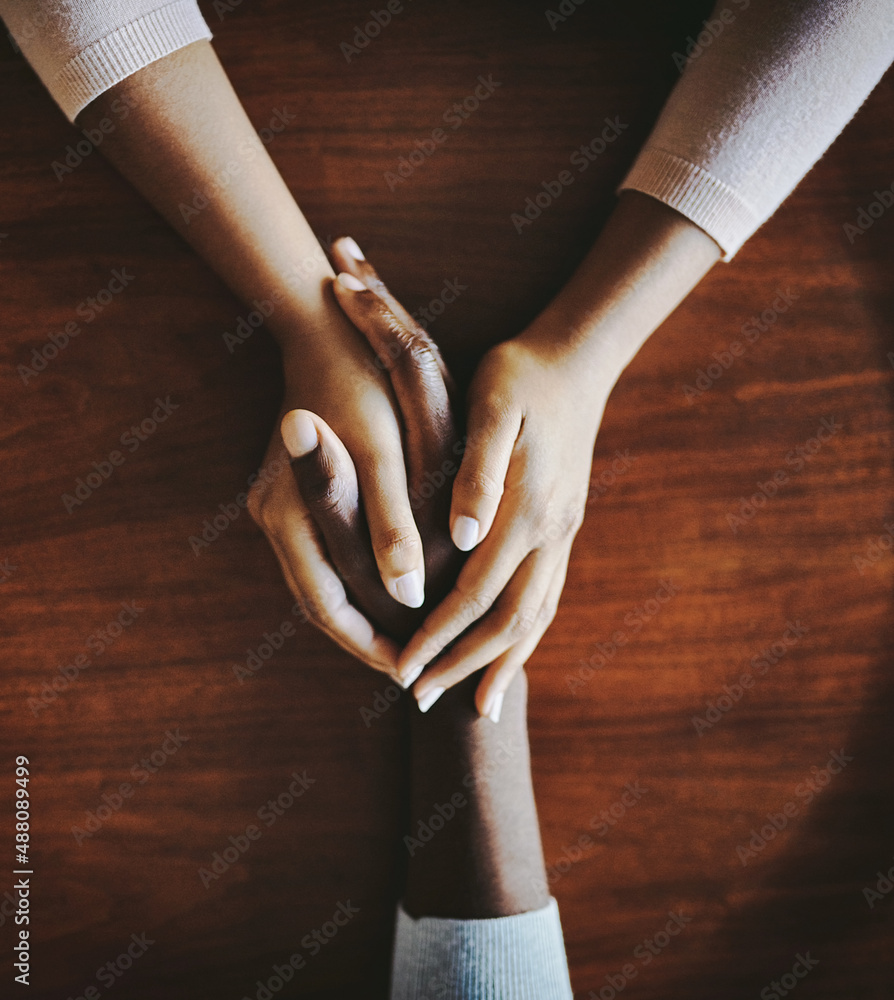 Compassion goes a long way. High angle shot of two people holding hands in comfort.