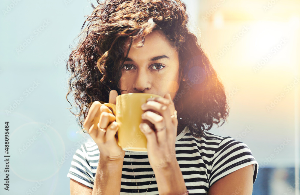 Coffee - check. Cropped shot of an attractive young businesswoman in her office.