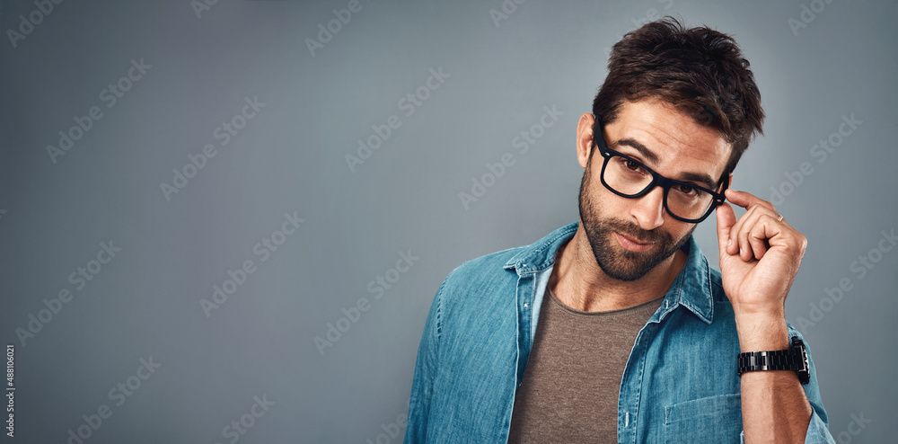 Looks good to me.... Studio shot of a handsome young man posing against a grey background.