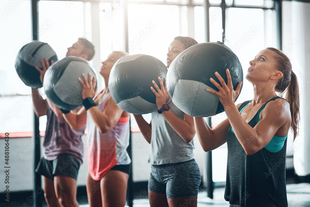 Put in the work. Shot of a fitness group working out at the gym.