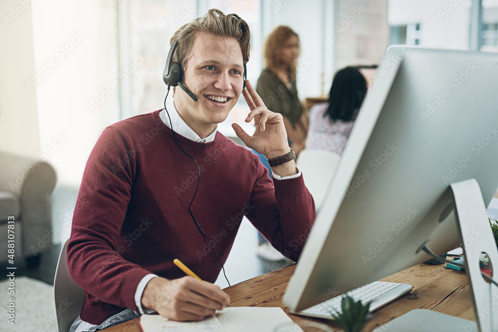 His expertise ensures queries are resolved first time round. Shot of a young man using a headset and