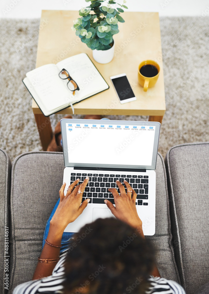 Trying to get work done at home. Shot of an unrecognizable woman working from home.