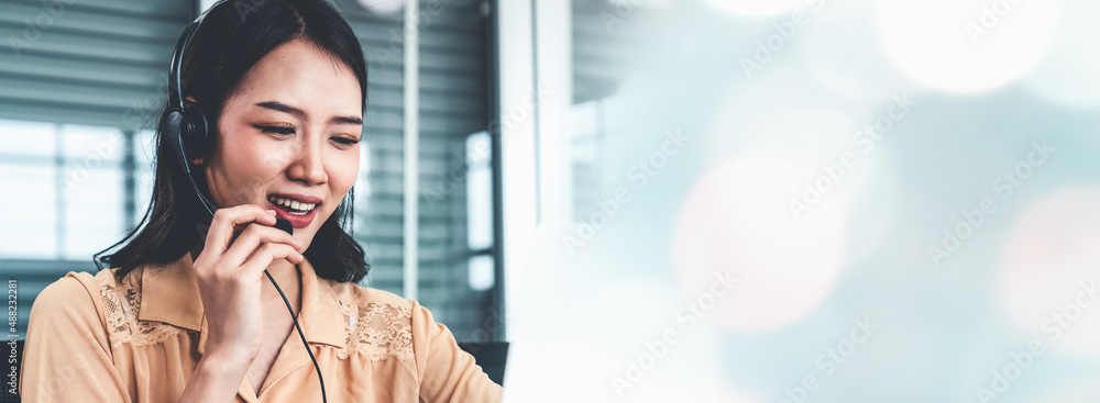 Businesswoman wearing headset working actively in office . Call center, telemarketing, customer supp