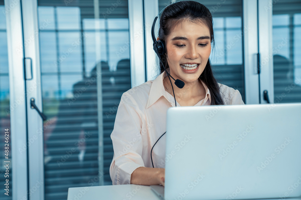 Businesswoman wearing headset working actively in office . Call center, telemarketing, customer supp