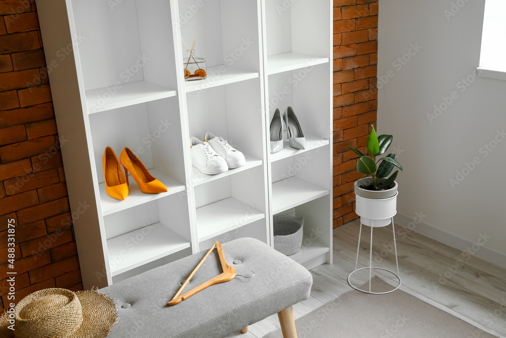 Shelf unit with shoes in interior of room